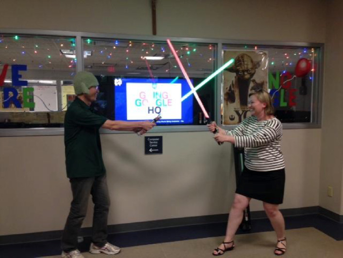 Two People with Lightsaber Toys