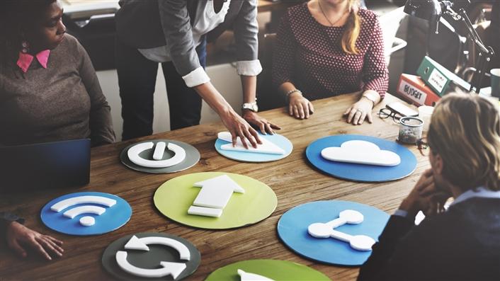 photo of group of people around a table making icon signage