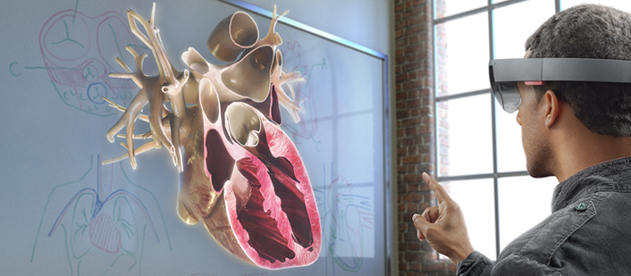 photo of man looking at a human heart cross-section through a VR headset