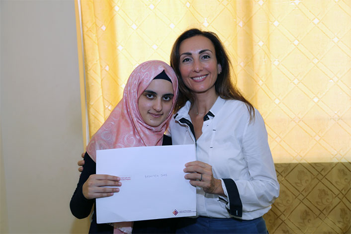 Maysa Jalbout and Badriyeh Diab holding up a piece of paper