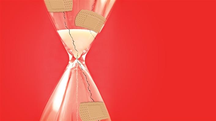 cracked and bandaided hourglass on a red background