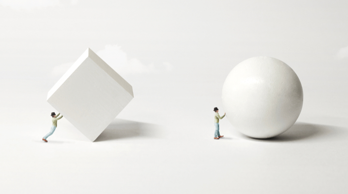 a person pushing a cube and a person pushing a sphere