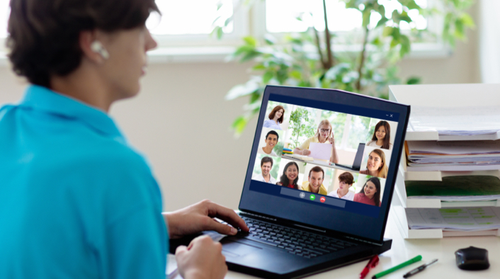 Student in front of laptop showing group video call