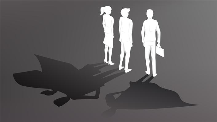 outlines of 3 people standing together in normal clothes. their shadows are wearing capes.