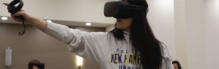 Person wearing VR goggles and pointing.