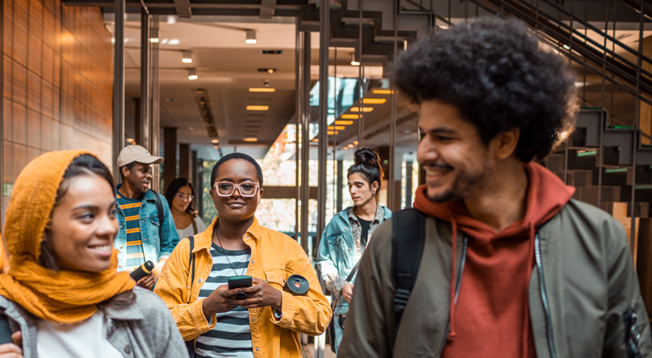 Students walking down a hallway while talking