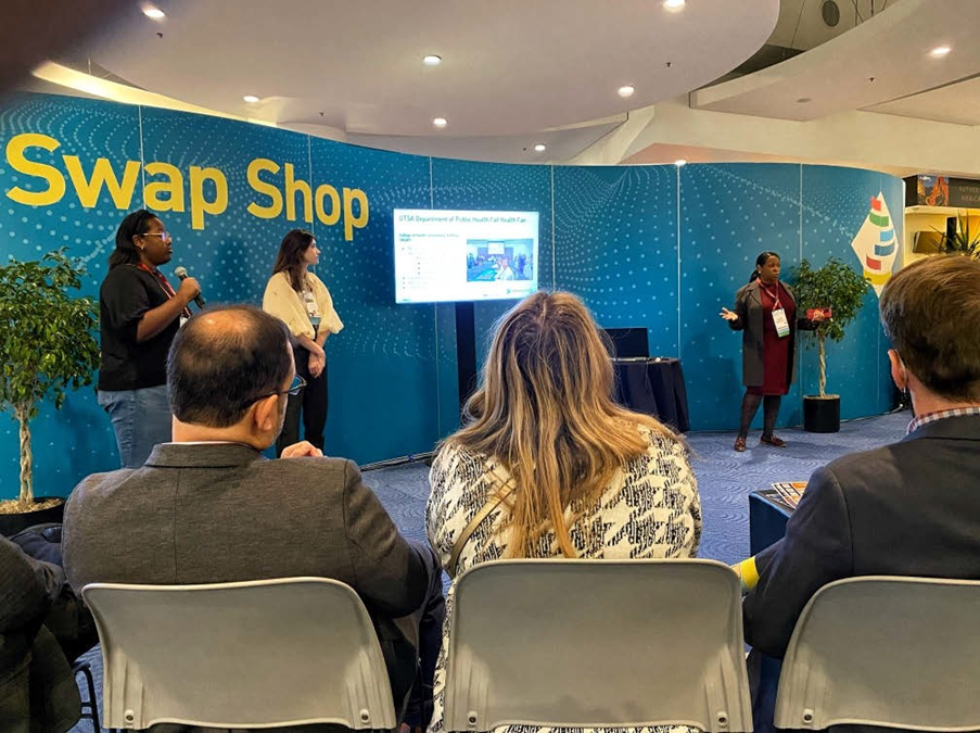 Photograph showing two UTSA students and a UTSA executive giving a presentation at the EDUCAUSE Annual Conference.