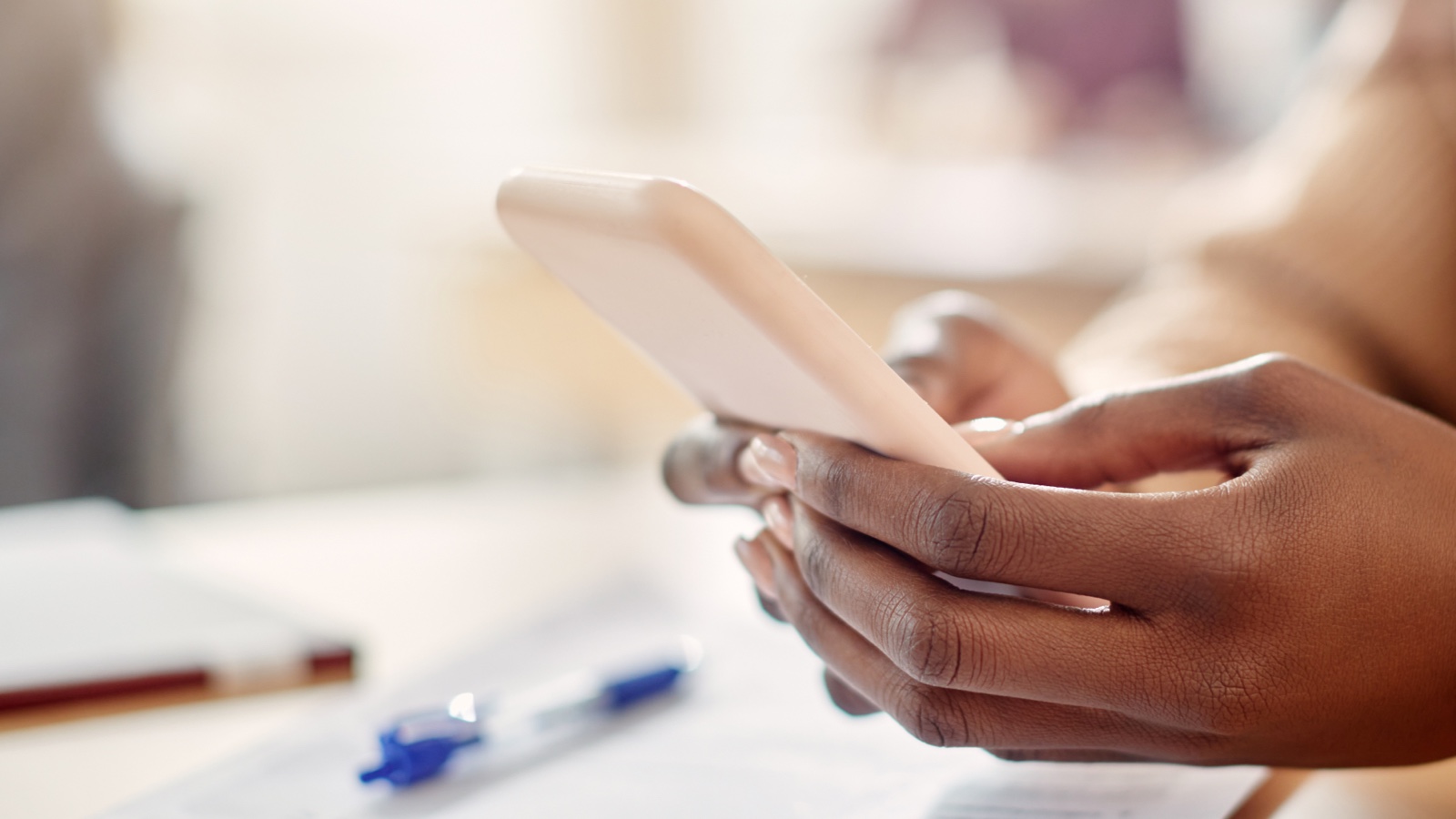 Hands holding and typing on a smartphone