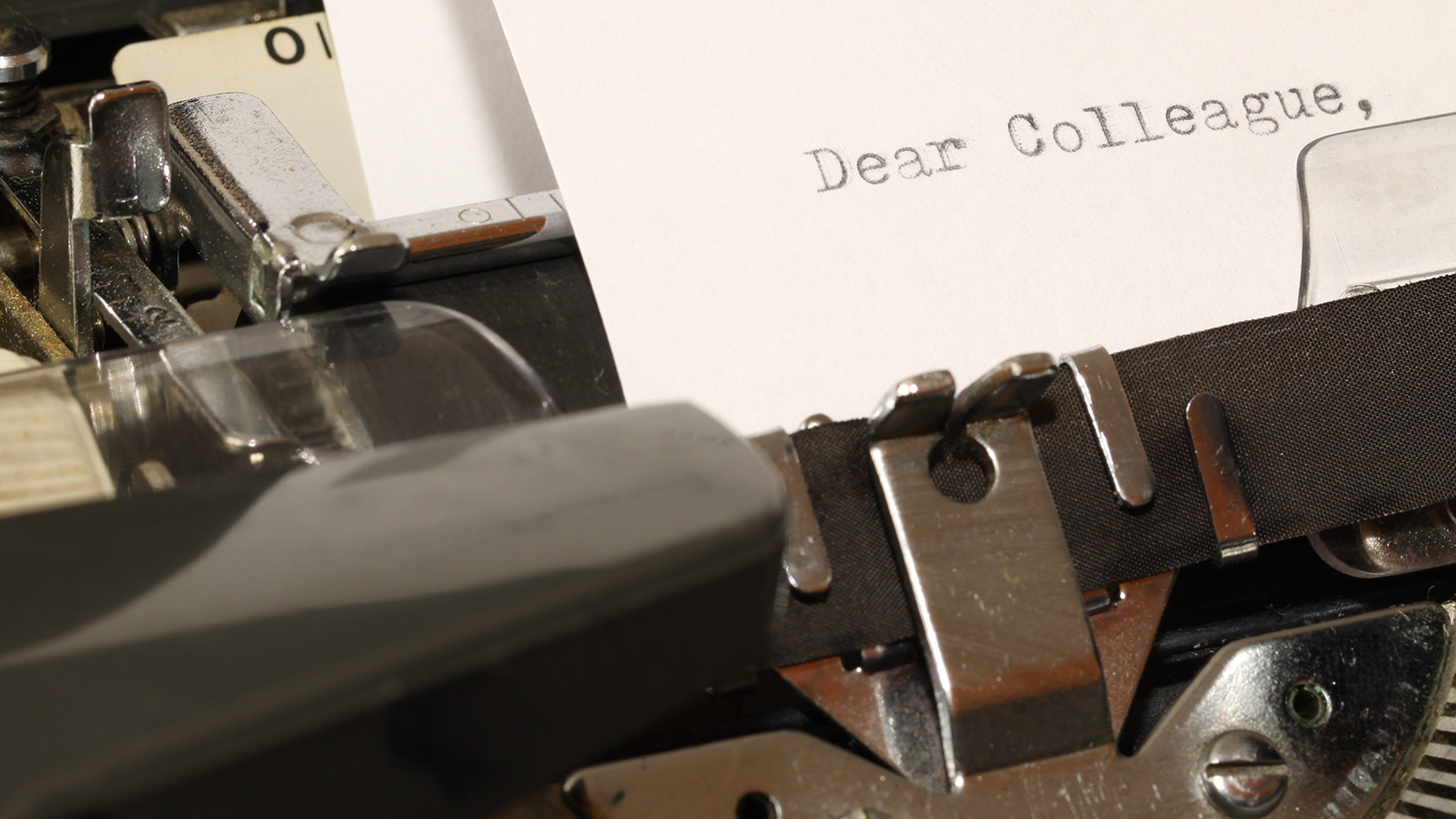 Page in a typewriter that says 'Dear Colleague,'