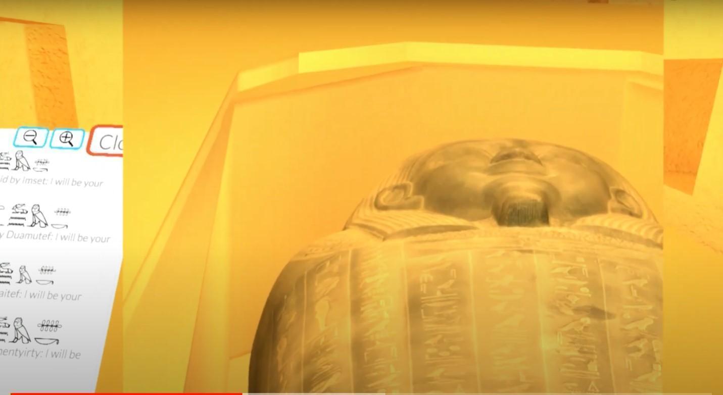 Screen shot from a VR experience showing a sarcophagus along with a panel on the side that shows translations of the hieroglyphics that are on the sarcophagus lid. 
