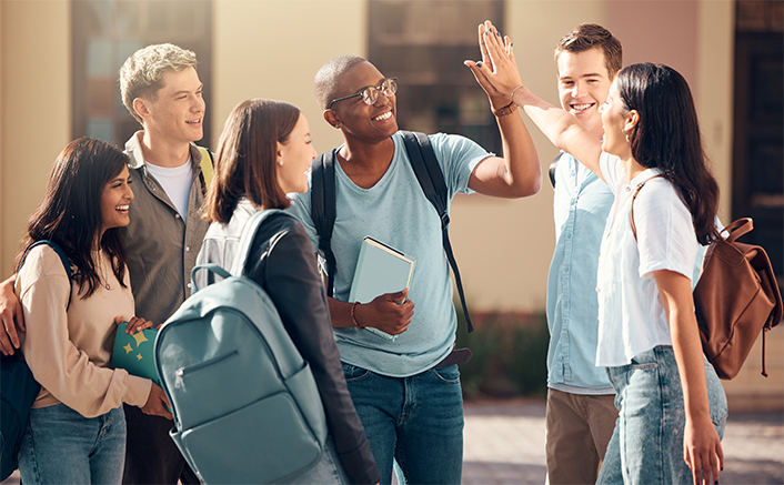 Group of students high-fiving each other