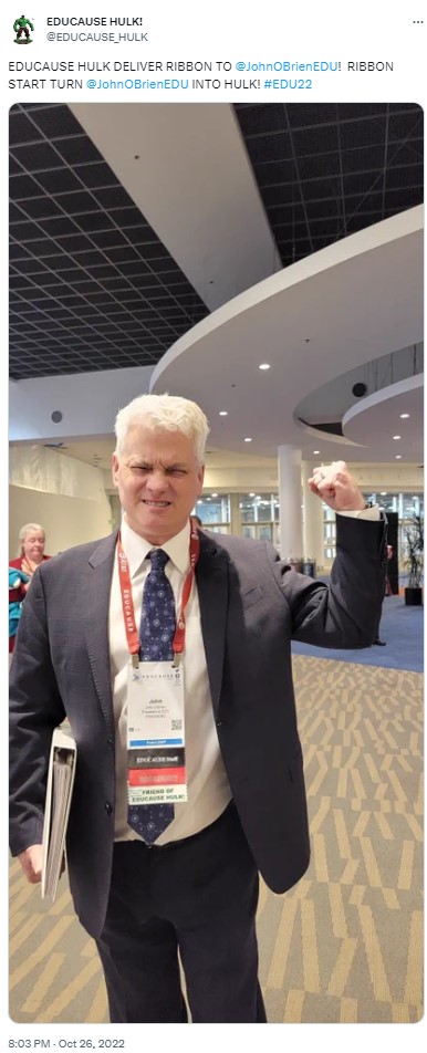 Tweet from EDUCAUSE Hulk. EDUCAUSE HULK DELIVER RIBBON TO @JohnOBRIENEDU! RIBBON START TURN @JohnOBrienEDU INTO HULK! #EDU22. Picture of John O'Brien looking angry.
