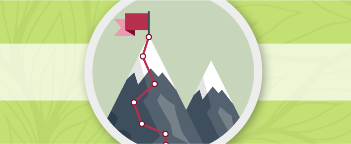 Trail up to a mountain peak with a flag on top