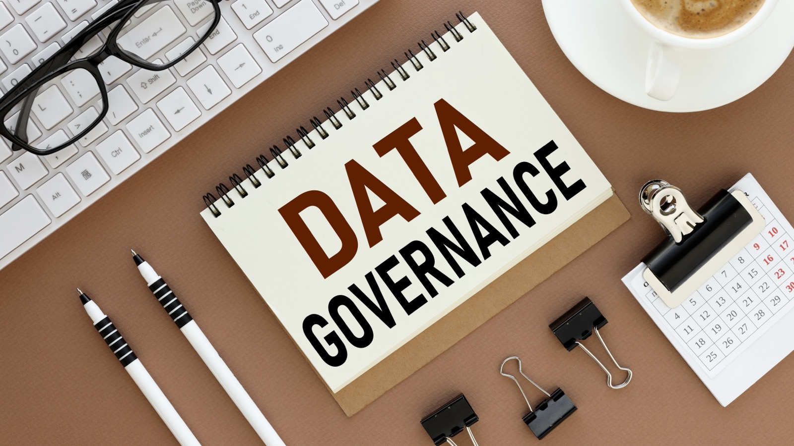 Desktop which has a notebook on it that says Data Governance.