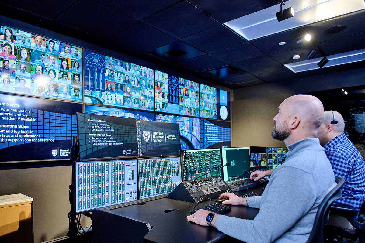 Photograph showing technical staff operating the LOC control room, using sophisticated video equipment to manage the cameras and views for the instructor and the students. 
