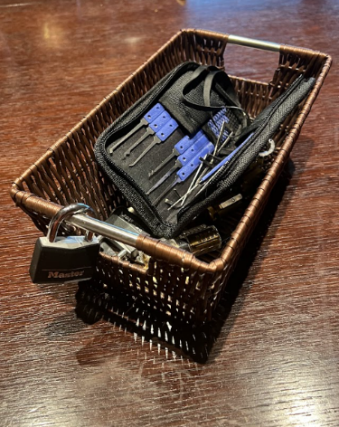 basket with lock picking tools and padlocks
