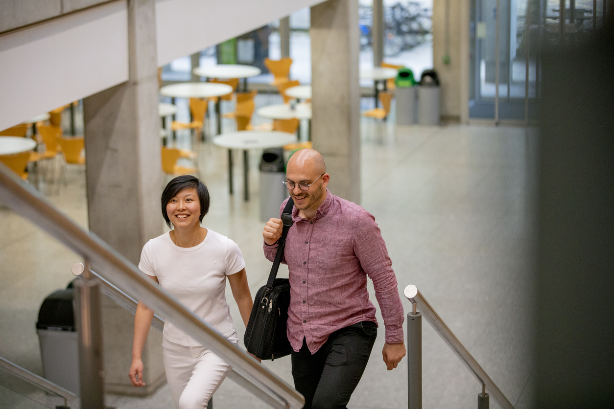 2 people walking up some stairs