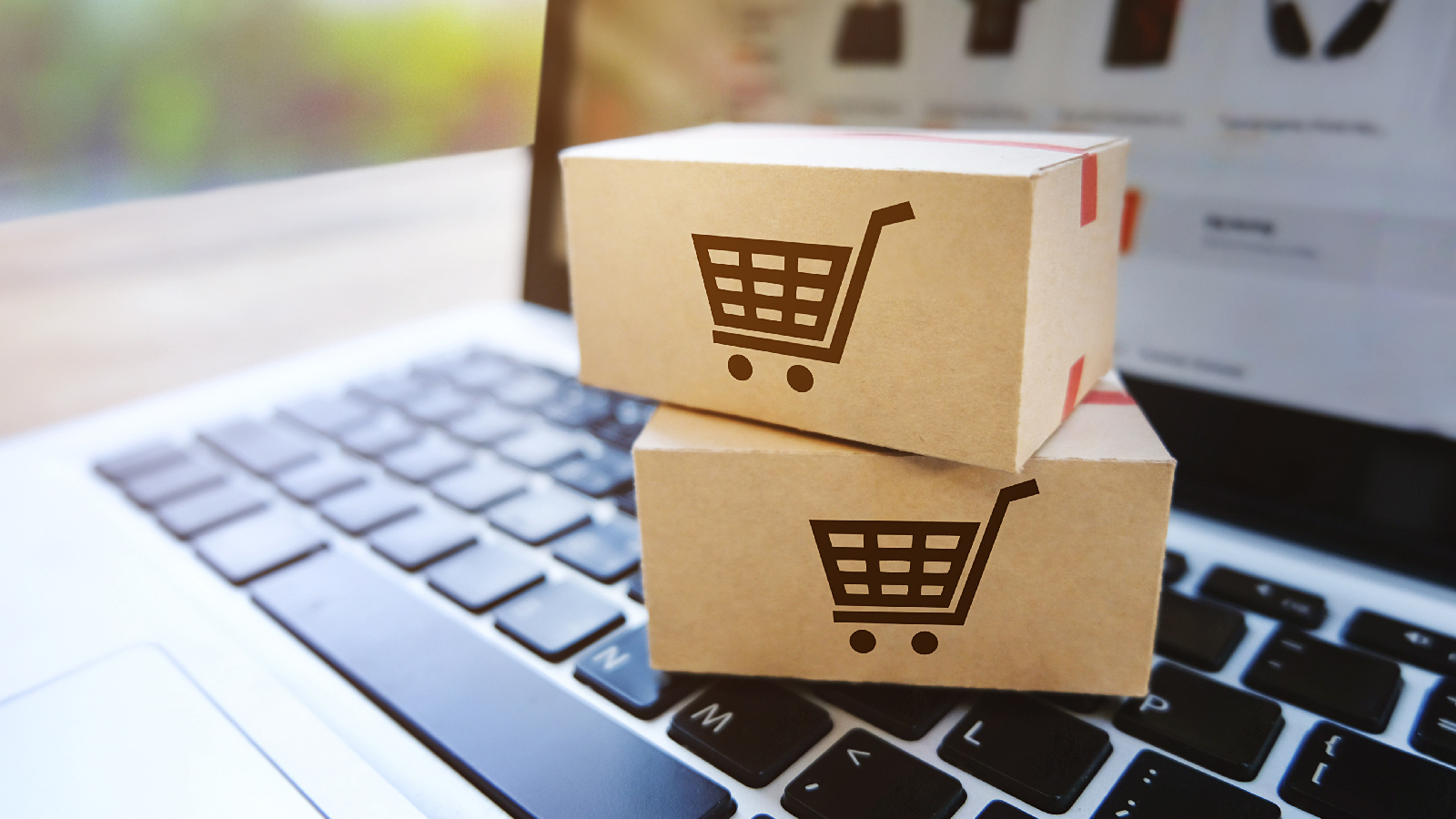2 boxes with shopping carts on the side sitting on top of a keyboard