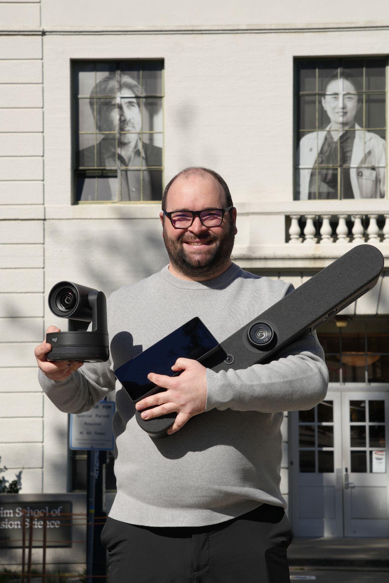 man holding camera and extra equipment