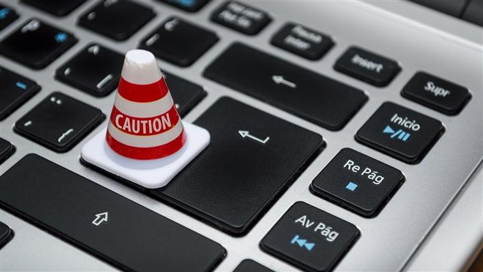 photo of miniature caution cone on a keyboard