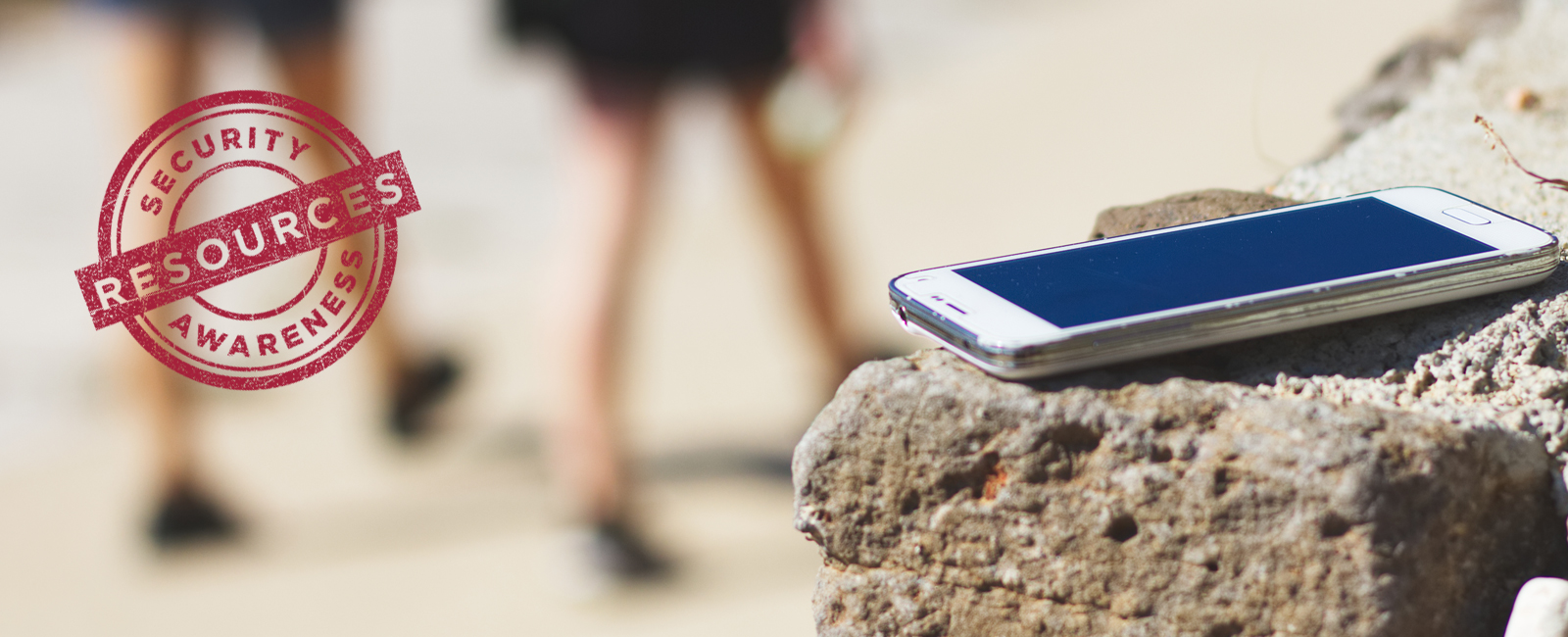 photo of mobile device sitting on stone wall