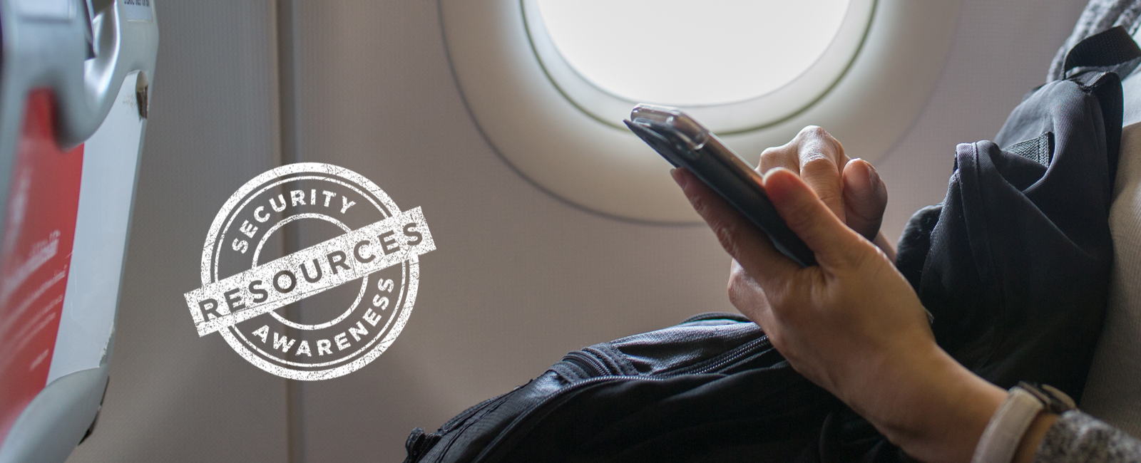 photo of person on airplane using mobile device