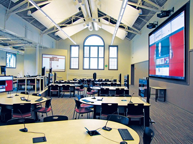 photo of active learning classroom tables, chairs, and projection screens