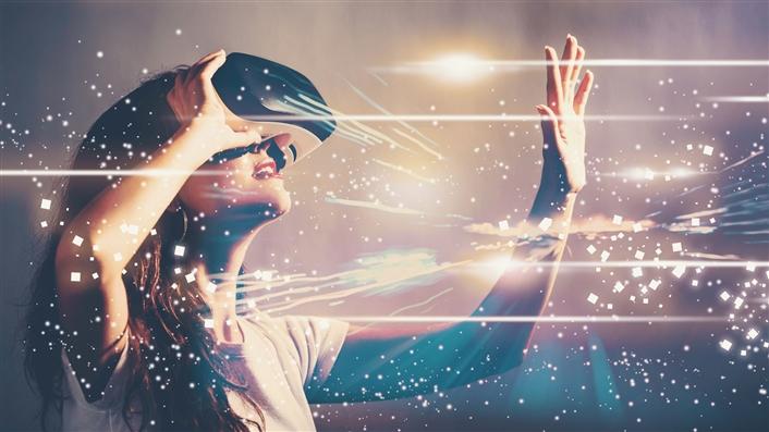 woman looking upward through VR headset with lighting effects all around her