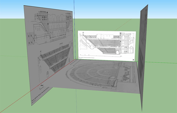 A gray panel on the left and right standing up and facing each other with a gray panel making a floor between them. A white panel at the back not quite spanning the width between the two gray panels.  Each panel has marking showing steps and seats in a schematic format.