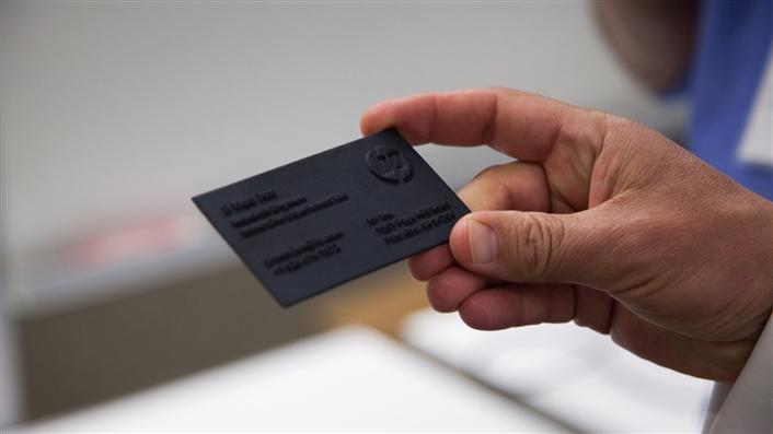 photo of person's hand holding a business card