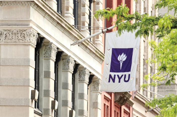 photo of NYU building with NYU pennant suspended from its facade