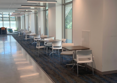 University of California–Irvine informal learning spaces, tables and chairs along a corridor wall