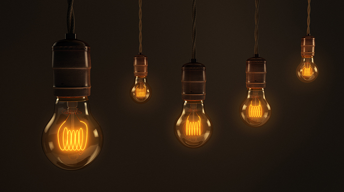 five light bulbs suspended in a dark space