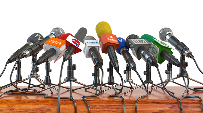 cluster of microphones on a wooden table