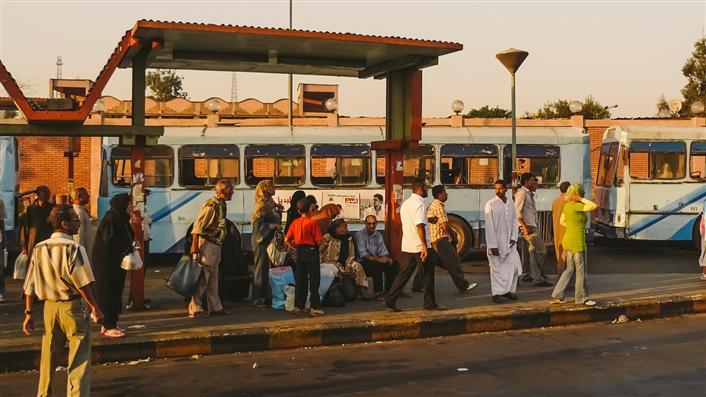 photo of passengers at a bustop