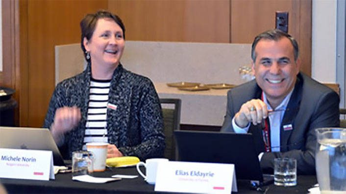 Michele Norin and Elias Edayrie sitting at a conference table.
