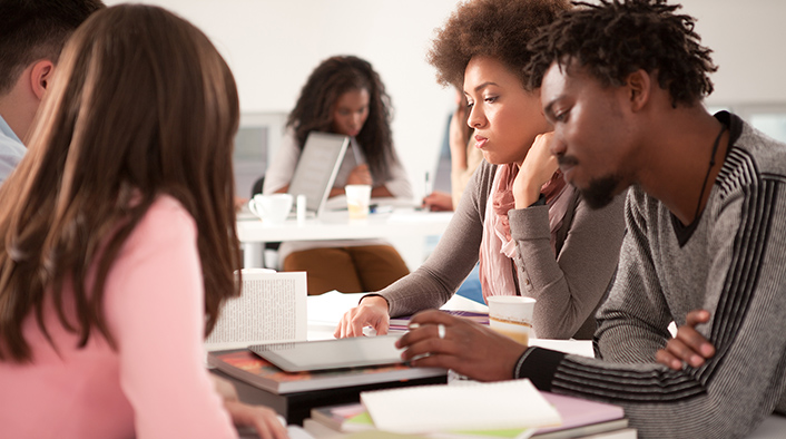 Group of college students studying together.