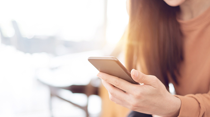 woman holding a mobile device