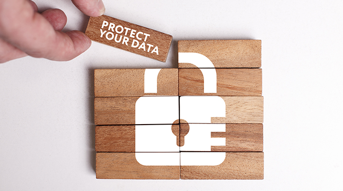 10-piece wood block puzzle of white lock with PROTECT YOUR DATA on the final piece