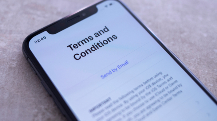 Smartphone with a document titled 'Terms and Conditions' on the screen