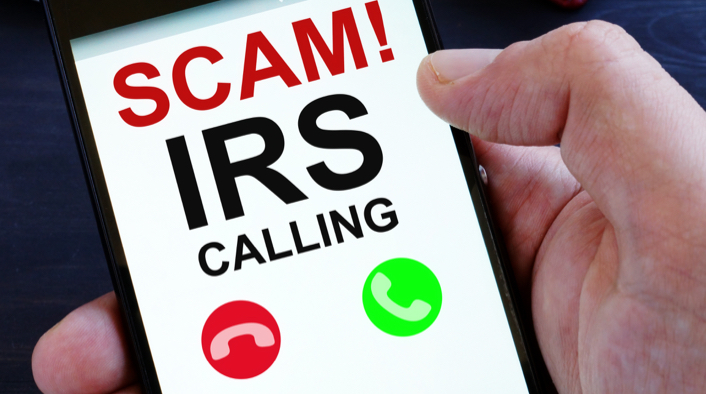 mobile phone displaying SCAM! IRS CALLING