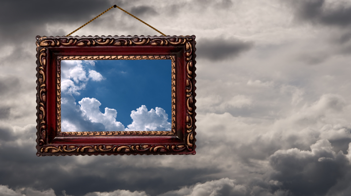 Framed image of blue sky with some clouds hanging in a cloudy sky
