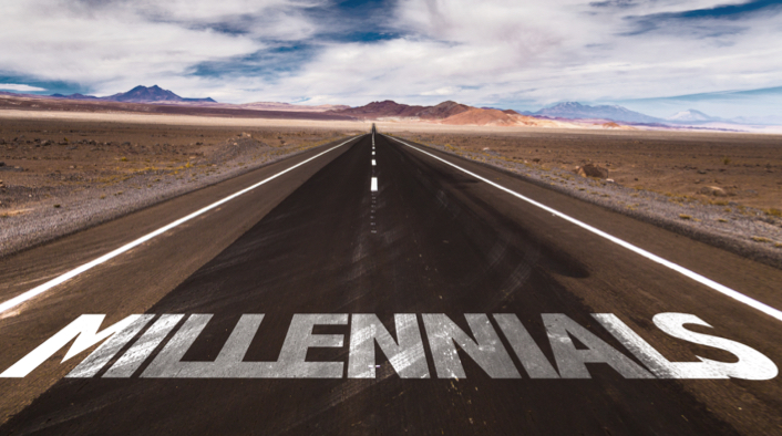 long straight desert highway with MILLENIALS painted in white across the pavement