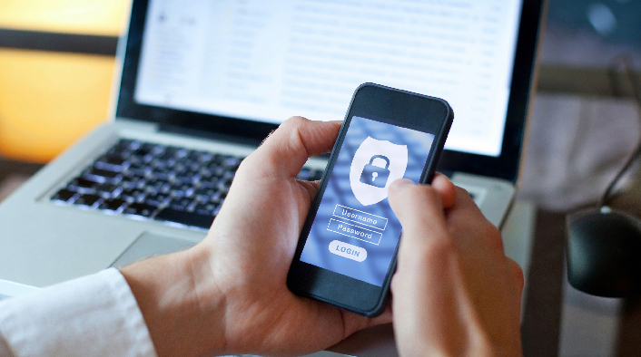 hands holding a smartphone which has a security login screen 