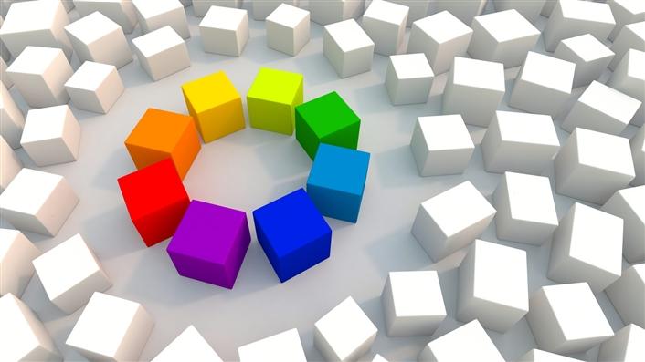 Eight cubes in varying colors arranged in a circle, surrounded by similar cubes that are all white