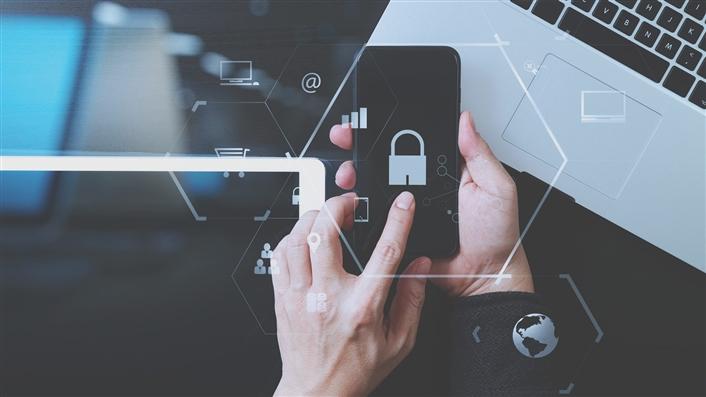 Hands holding a mobile phone with security icons