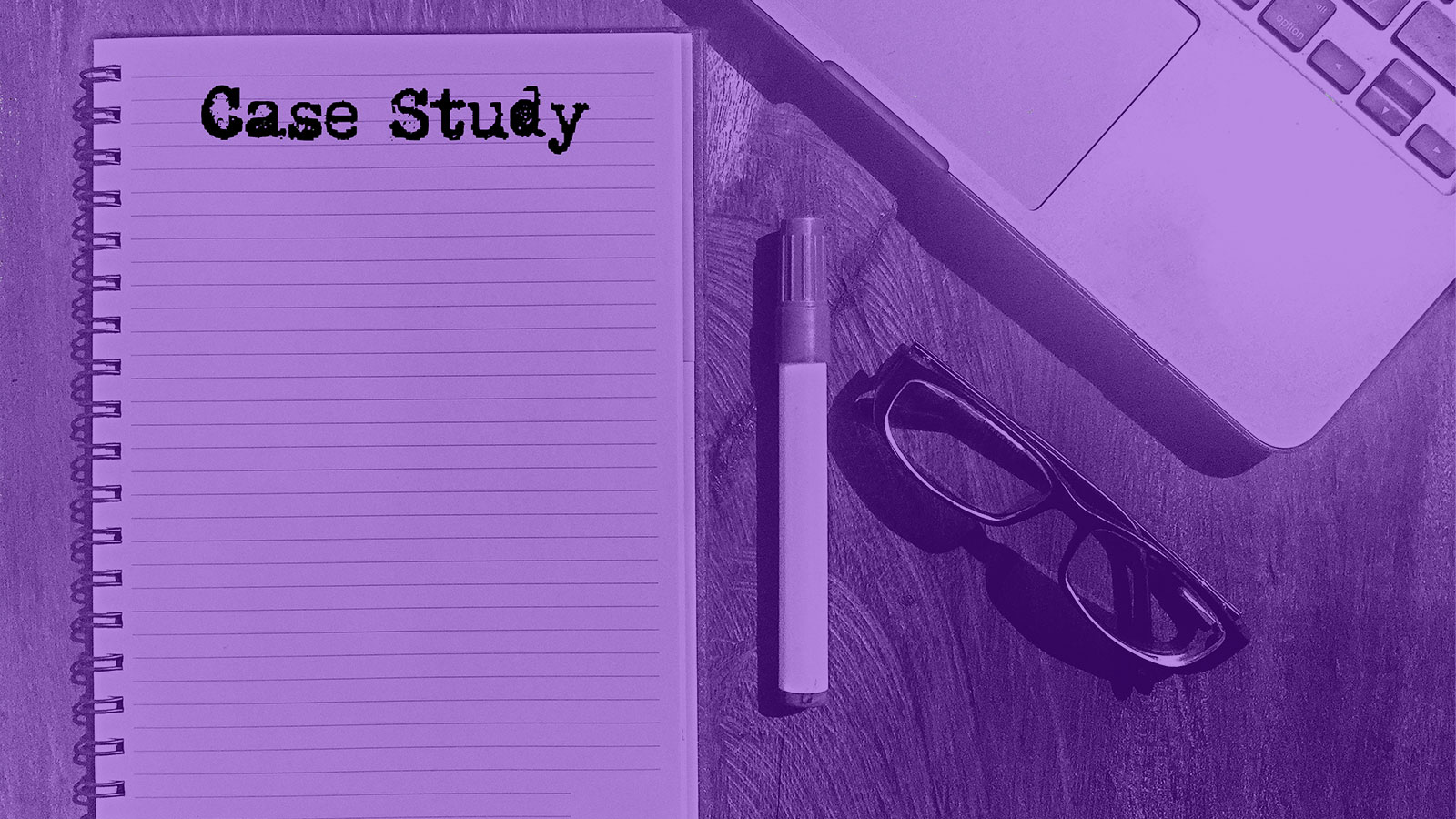 Open notebook displaying the words Case Study next to a laptop, pen, and eyeglasses.